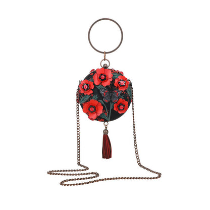 Decorative keychain with floral design and tassel on a white background