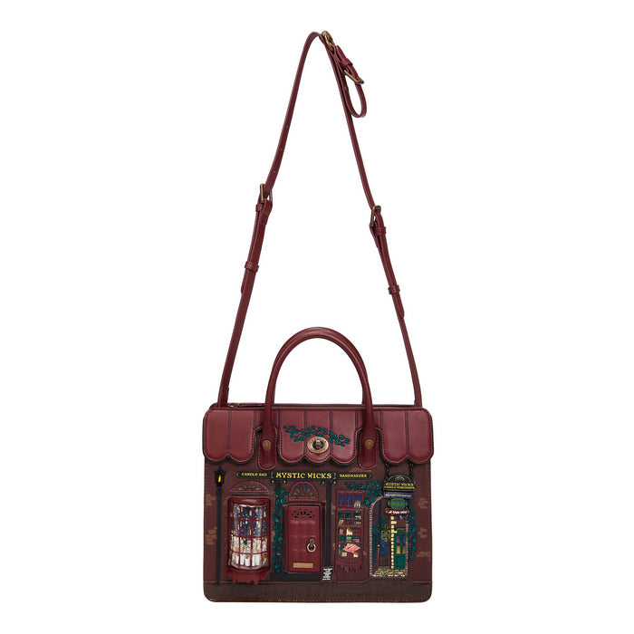 Brown leather bag with detailed design on a white background