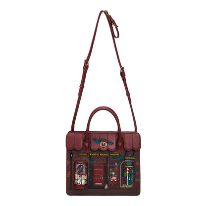 Brown leather bag with detailed design on a white background