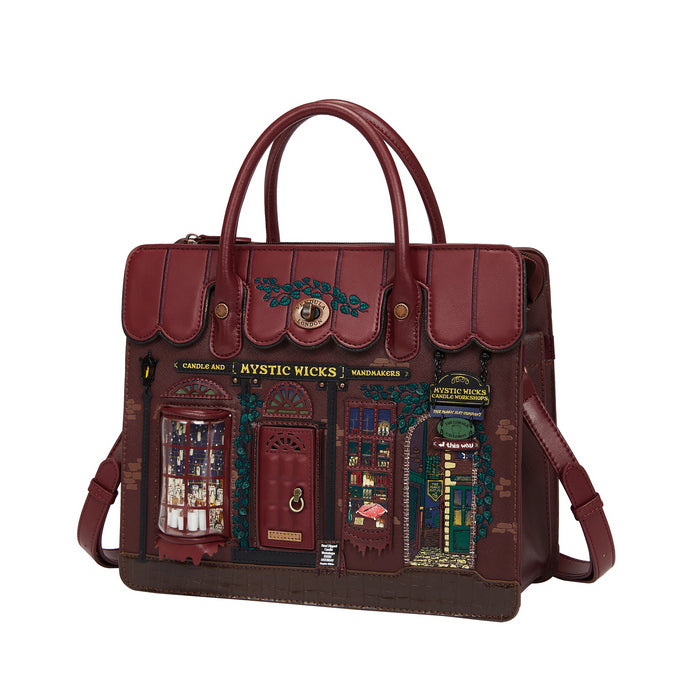 Red handbag with detailed design on a white background