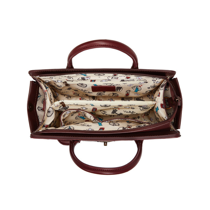 Brown handbag with a patterned interior on a white background