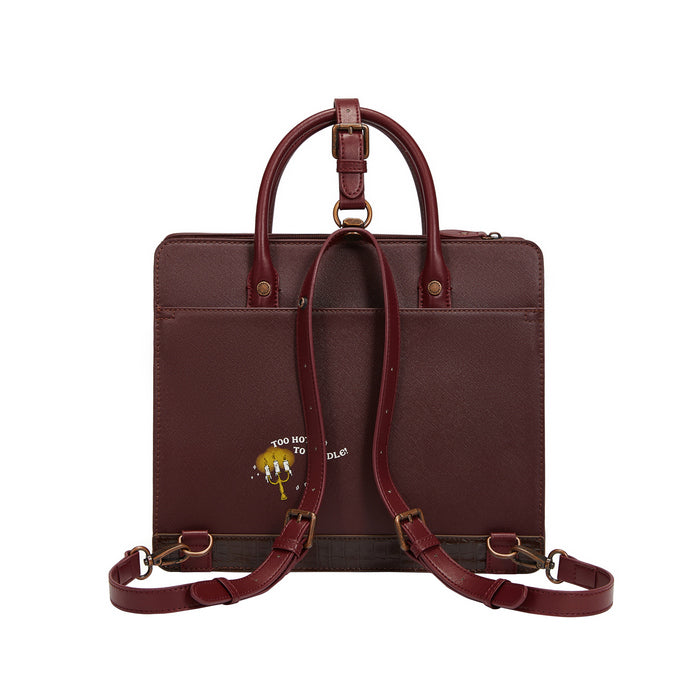 Brown leather briefcase with shoulder strap on a white background