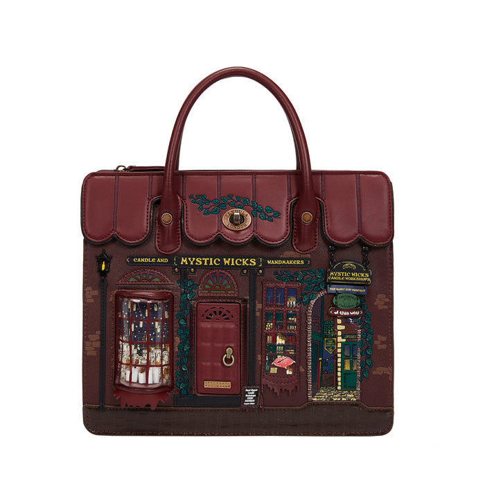 Designer handbag with detailed facade design on a white background