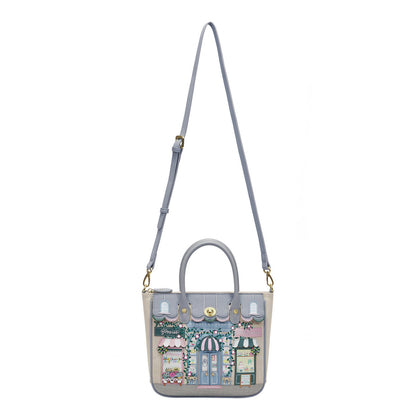 Handbag with a detailed design of a street scene on a white background