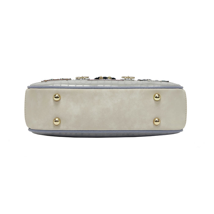 Beige handbag with gold studs on a white background