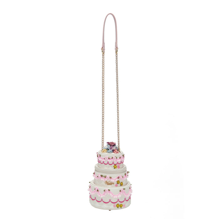 Three-tiered cake-shaped bag with pink details on a white background
