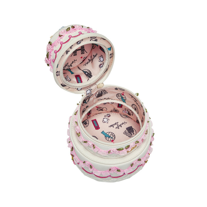 Decorative jewelry box with pink interior and intricate designs on a white background