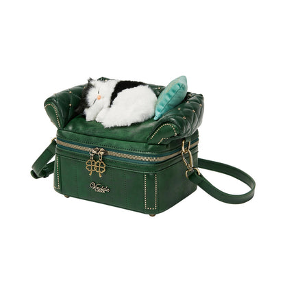 Green handbag with a plush cat toy on a white background