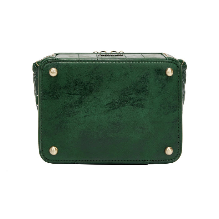 Green leather handbag with gold studs on a white background