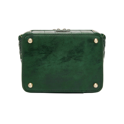 Green leather handbag with gold studs on a white background