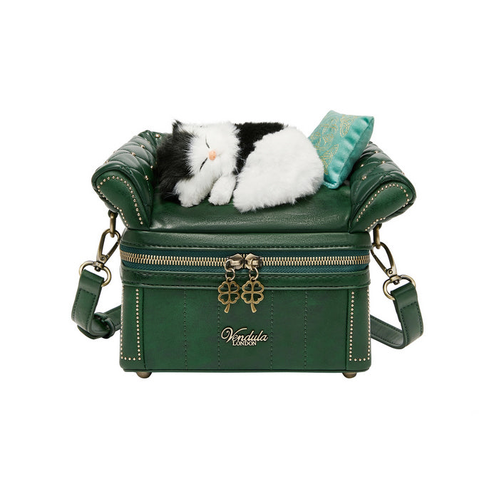 Green leather bag with a plush cat toy inside on a white background