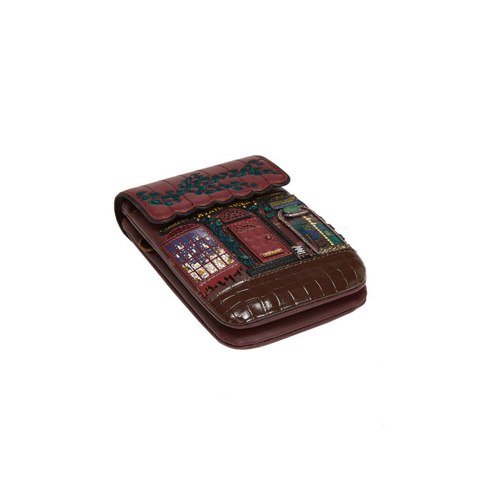 Brown leather wallet with embroidered design on a white background