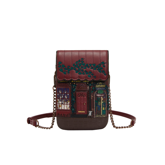 Brown leather handbag with decorative embossing on a white background