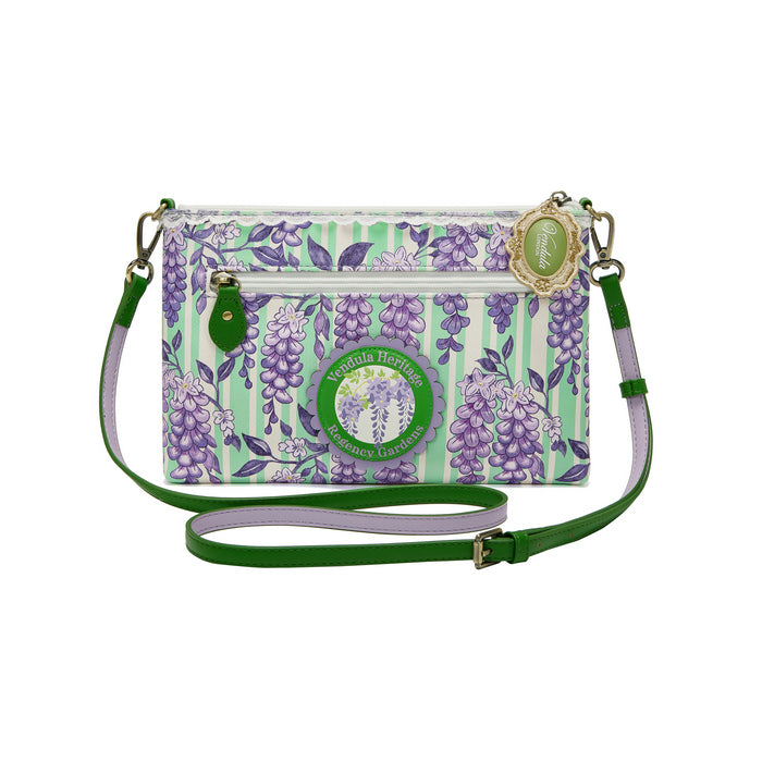 Floral patterned crossbody bag with green strap on a white background