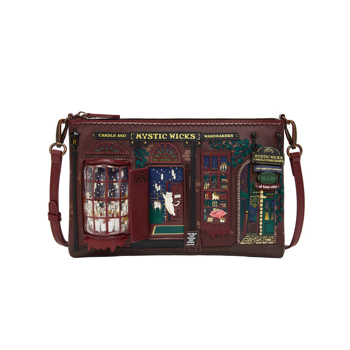 Brown leather crossbody bag with detailed design and 'Mystic Wicks' branding on a white background