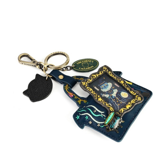 A Louis Vuitton 'The Love Collection' keychain bag featuring a dark blue leather pouch with an illustrated celestial design, a black cat-shaped charm, and gold-tone hardware.