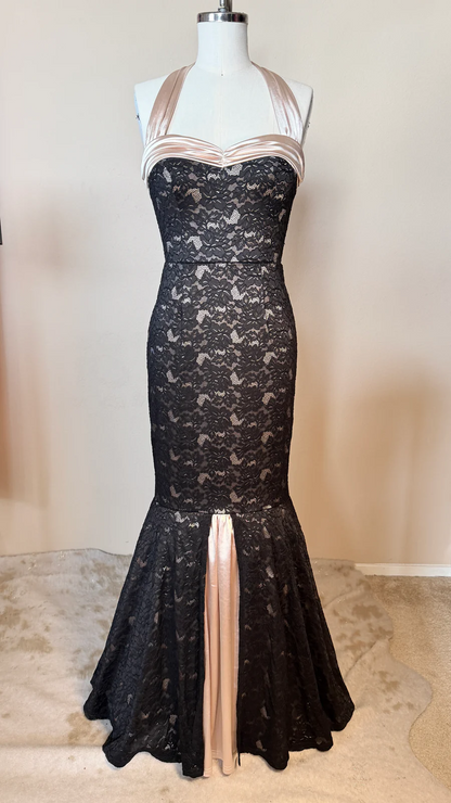 Black lace dress with a high slit on a mannequin against a neutral background