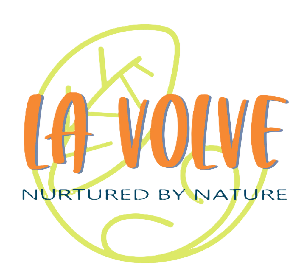 A logo-style graphic with the words 'LA VOLVE' in orange letters outlined in blue, with 'NURTURED BY NATURE' below in dark blue text, overlaid on a pale yellow abstract line drawing on a white background.