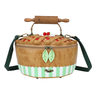 Picnic basket-shaped handbag with wooden handle and green strap on a white background