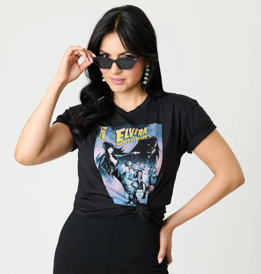 Woman wearing a black t-shirt with Elvira design, posing against a plain background