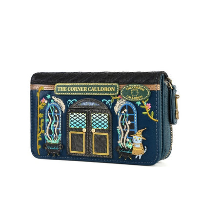 A navy blue zip-around wallet featuring detailed embroidery of 'The Corner Cauldron' from Harry Potter, including a cauldron, windows, and a wizard character, shown on a white background.