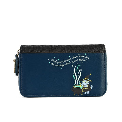 A navy blue zip-around wallet with a black woven top panel, featuring a cartoon witch character by a cauldron and white cursive text on the front, shown against a plain white background.
