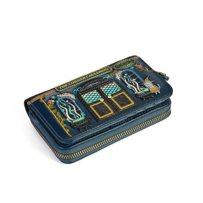 A dark teal zip-around wallet featuring a highly detailed, colorful embroidered patch of a gothic-style door labeled 'The Corset Catacombs' on the front, set against a plain white background.