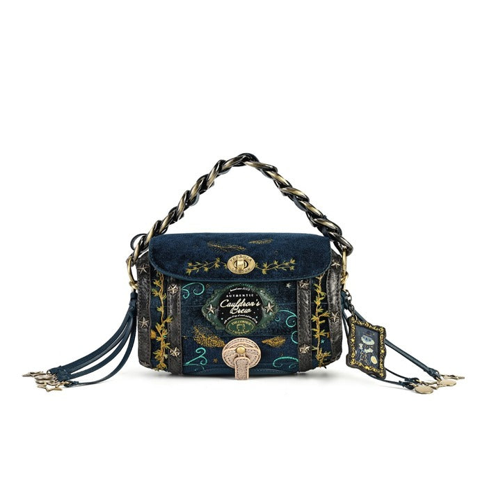 A dark blue velvet and patterned fabric handbag with gold and black decorative details, a braided top handle, and tassel straps, shown on a plain white background.