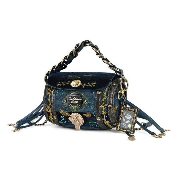 A whimsical dark blue velvet shoulder bag with gold and silver chain straps, featuring embroidered celestial patterns, a gold clasp, and dangling charm details on a white background.