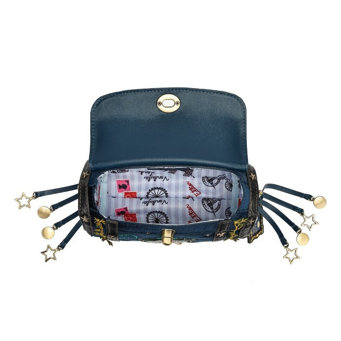 A dark teal blue leather clutch bag shown open, featuring a patterned lining with red and black illustrations, and multiple dangling black cords with gold star and ball charms on both sides.