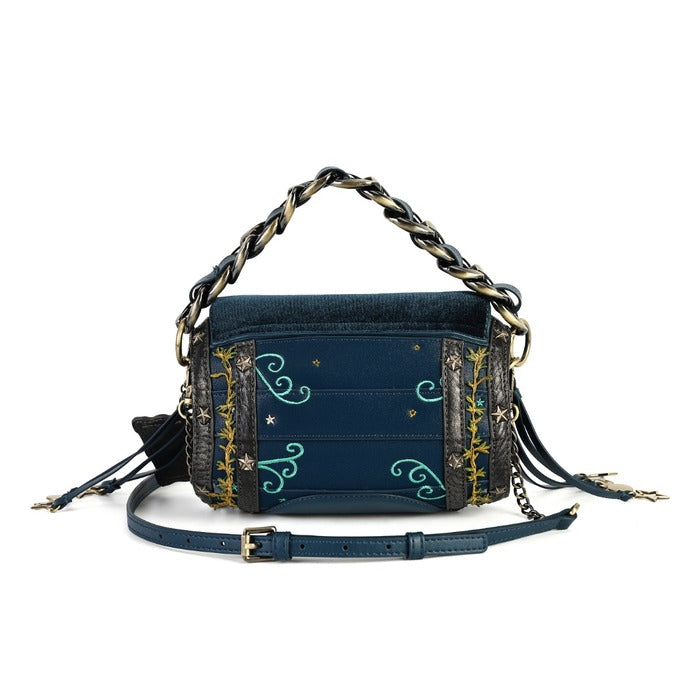 A navy blue denim crossbody bag with gold and turquoise embroidery, featuring a chunky chain handle, a detachable leather strap, and tassel details, shown against a plain white background.