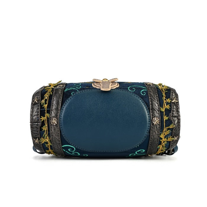 A navy blue cylindrical clutch bag with a central oval panel, decorated with gold embroidered vines, stars, and a gold bee clasp, set against a plain white background.