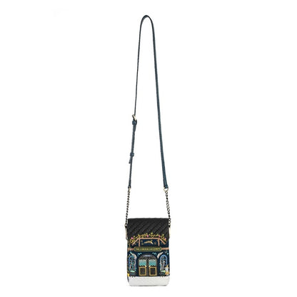 A black quilted crossbody bag with a long dark strap and a detailed architectural illustration on the front pocket, set against a plain white background.