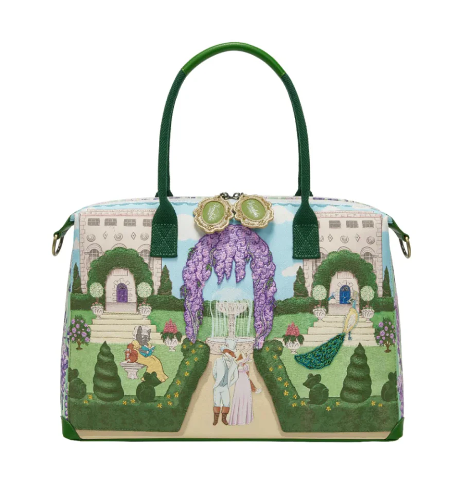 Woman holding a colorful handbag with a fairy tale design against a purple background with flowers.