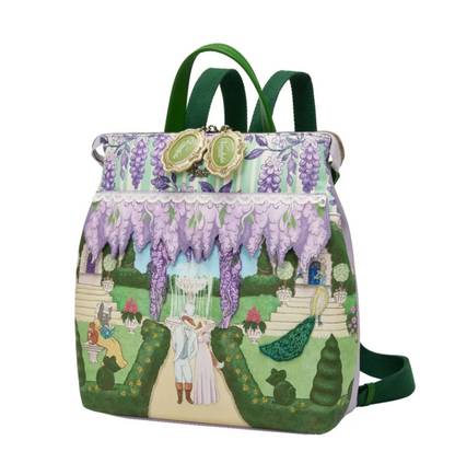 Person wearing a colorful backpack with a garden scene design.