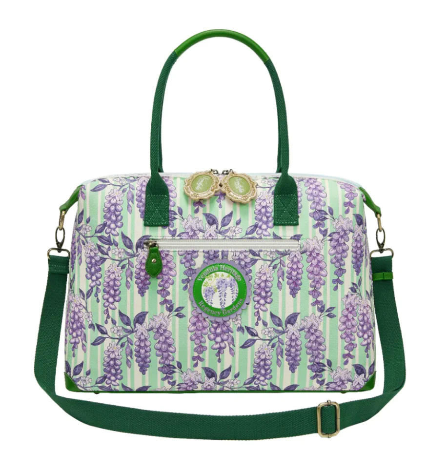 Woman holding a colorful handbag with a fairy tale design against a purple background with flowers.