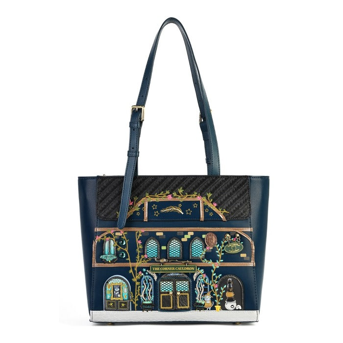 A navy blue tote bag featuring a detailed illustration of 'The Golden Calendar' building facade on the front, with a black carbon-fiber patterned upper panel and dark blue leather shoulder straps.