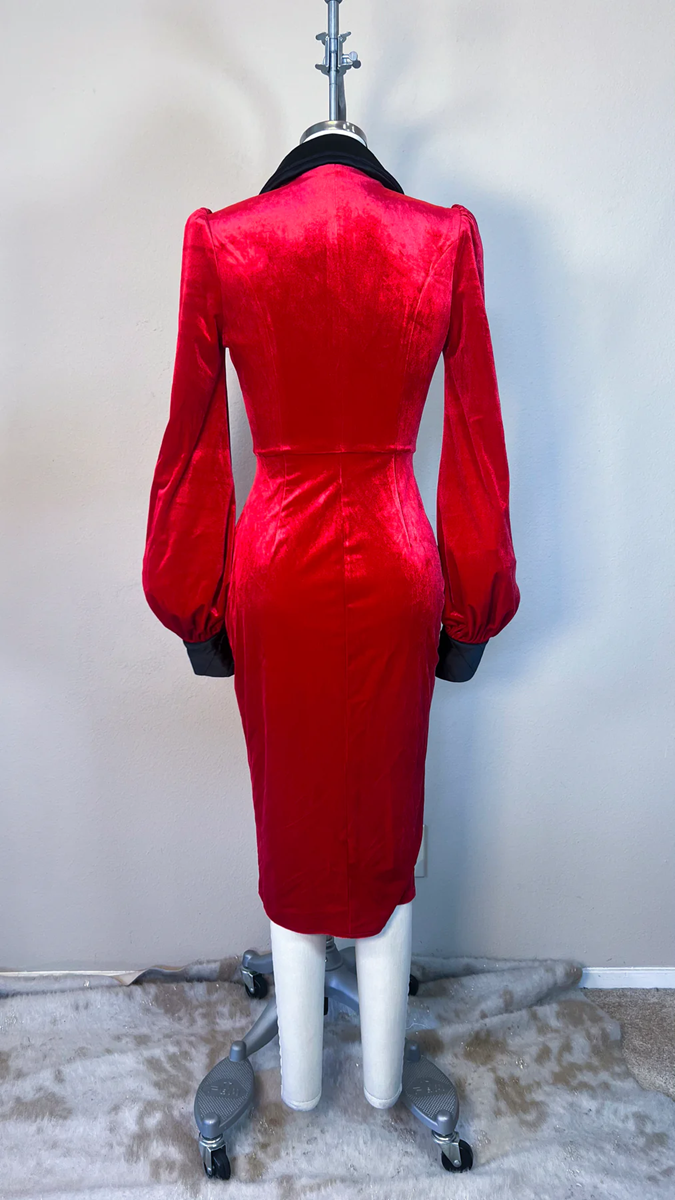 Red dress on a mannequin against a plain background