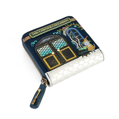 A small zip-around wallet featuring an illustrated storefront design with the text 'THE CORNER COUNTER' and a decorative blue sign, shown on a plain white background.
