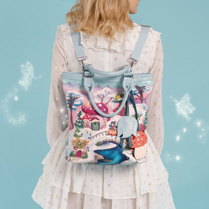 A versatile carryall that can be worn as a backpack, shoulder bag, crossbody or grab tote, with a padded tech section and organised internal storage. Embroidery and appliqué add texture to artwork featuring snowy toadstool houses, fairy doors, winter trees, rabbits and snowflakes.