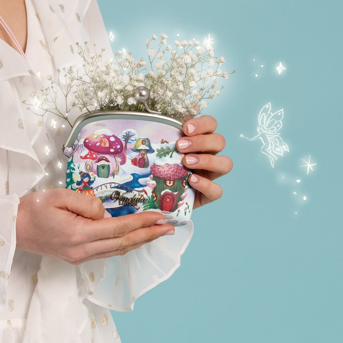 A compact clip-frame purse that can also be worn as a mini crossbody with the detachable chain strap. Embroidery, appliqué and internal card slots combine with snowy toadstool houses, fairy doors, winter trees, rabbits and snowflakes in a small but versatile design.