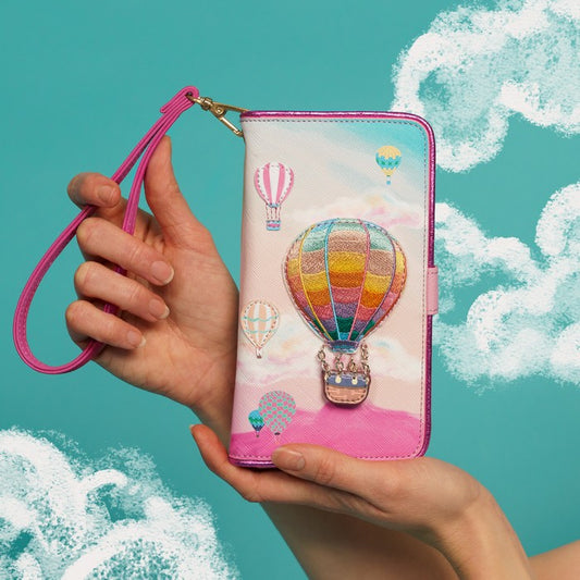 Hand holding a phone case with hot air balloon design against a teal background with cloud illustrations
