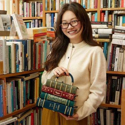 Woman holding books in a library setting