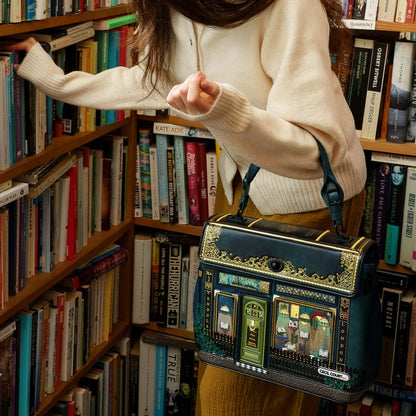 Person holding a decorative bag in a bookstore