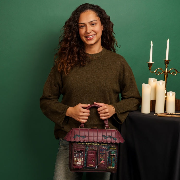 Woman holding a decorative bag with candles in the background