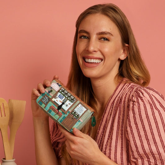 Woman holding a decorative box with a pink background