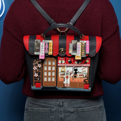 Person wearing a red and black backpack with decorative design