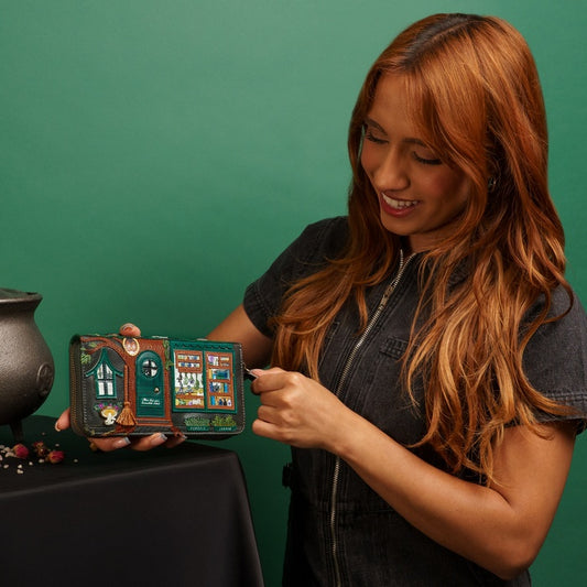 Woman holding a small, intricately designed box with a green background