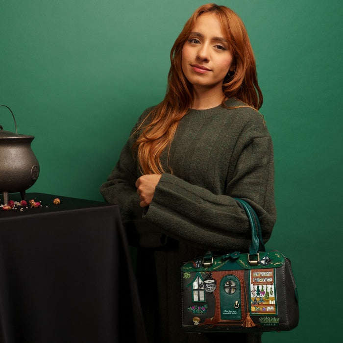 Woman holding a themed handbag against a green background