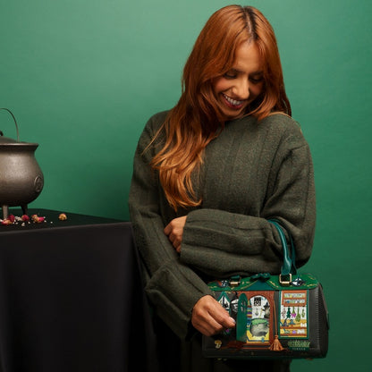 Woman holding a green handbag with decorative design against a green background